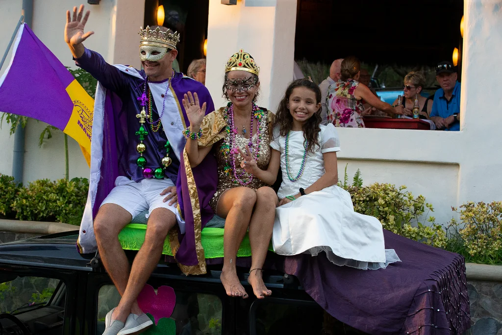 Community members dressed in Mardi Gras costumes riding on a parade float at the Playa Flamingo Mardi Gras celebration, Guanacaste, Costa Rica
